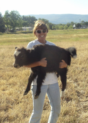 woman holding yak calf